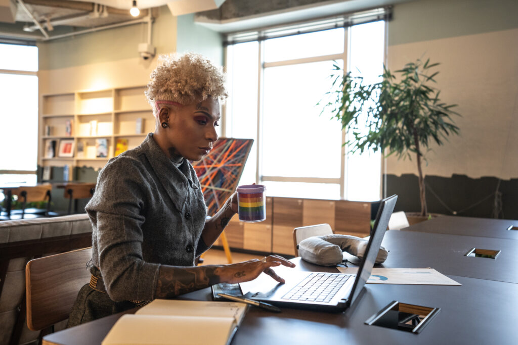 Mid adult businesswoman working with technology at coworking